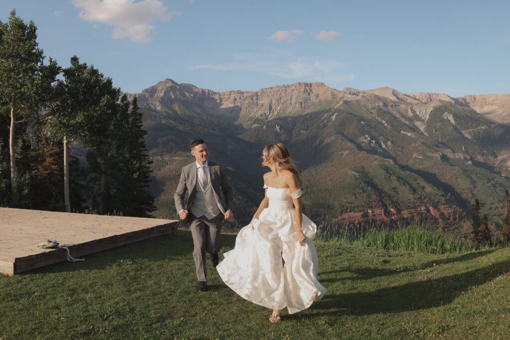 couple running in telluride mountains