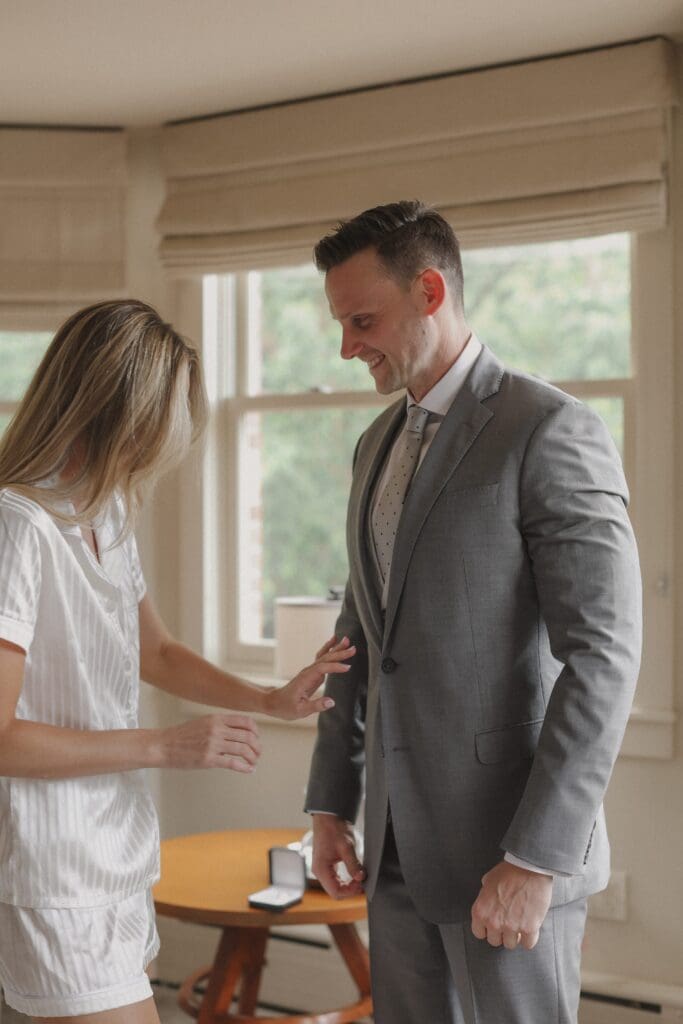 bride helping groom get ready