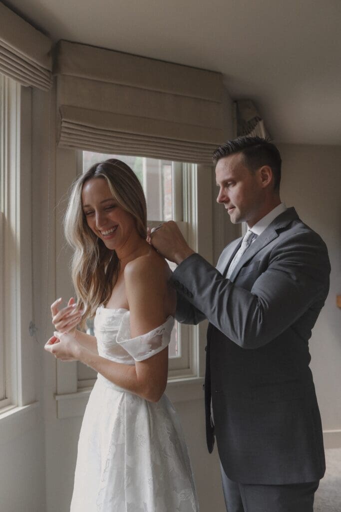 groom helping bride get ready