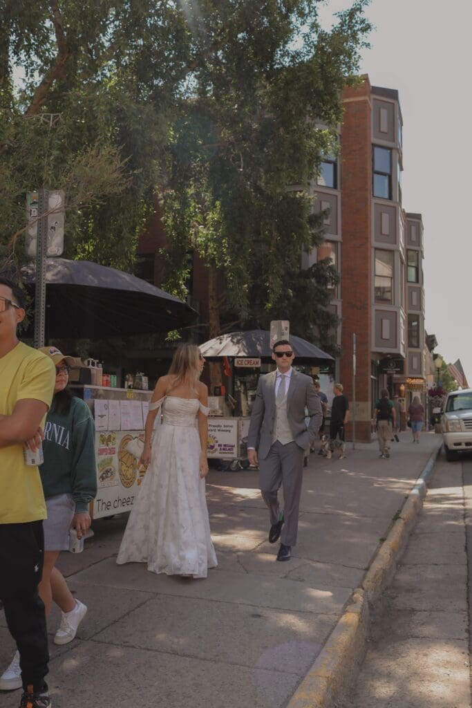 couple eating hot dogs on wedding day